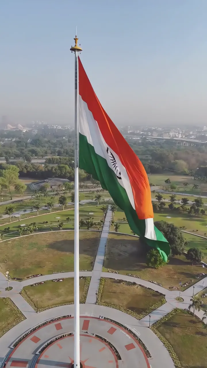 India Flag Flying High With Ashoka Chakra And Green Park