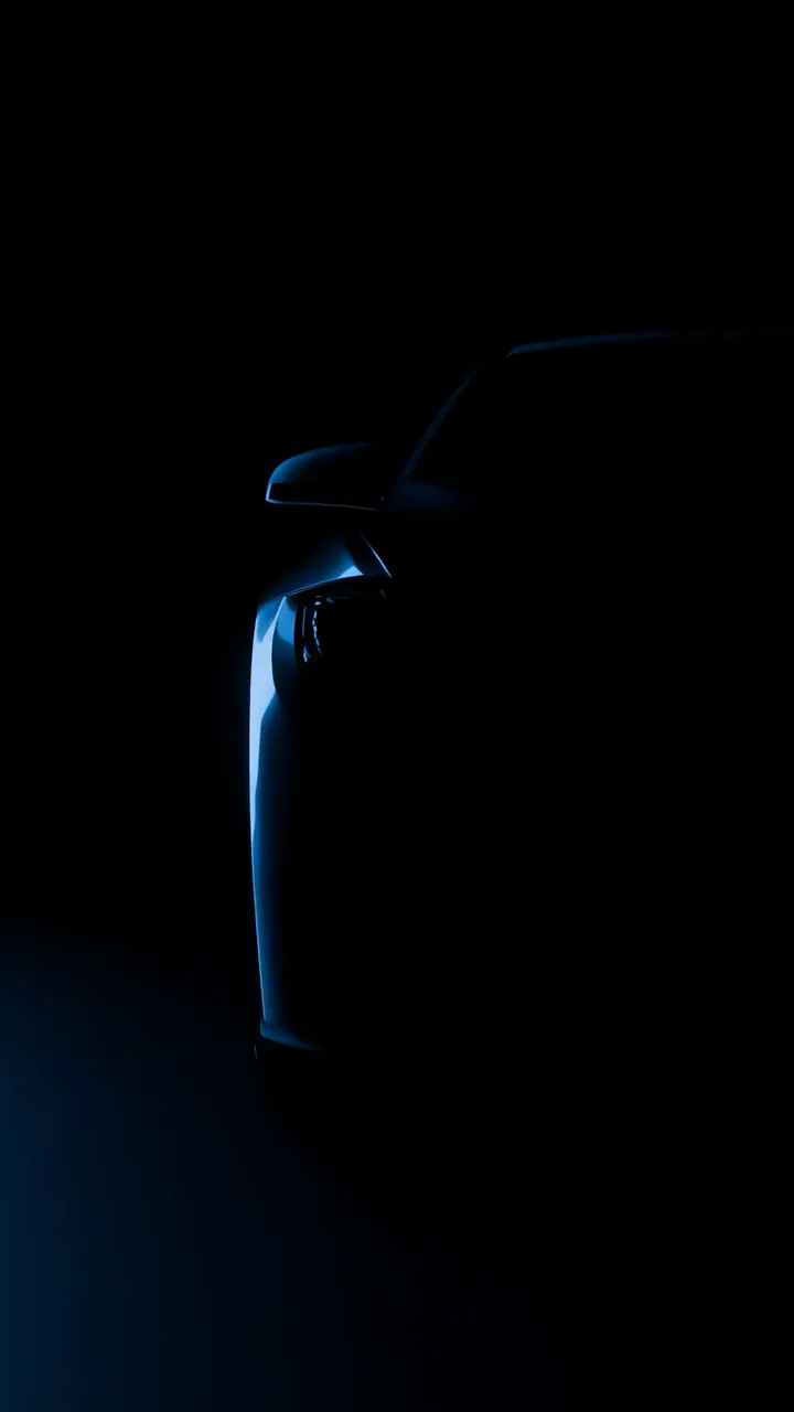 BMW in Motion: Sleek Blue Glow Luxury Car Night Scene