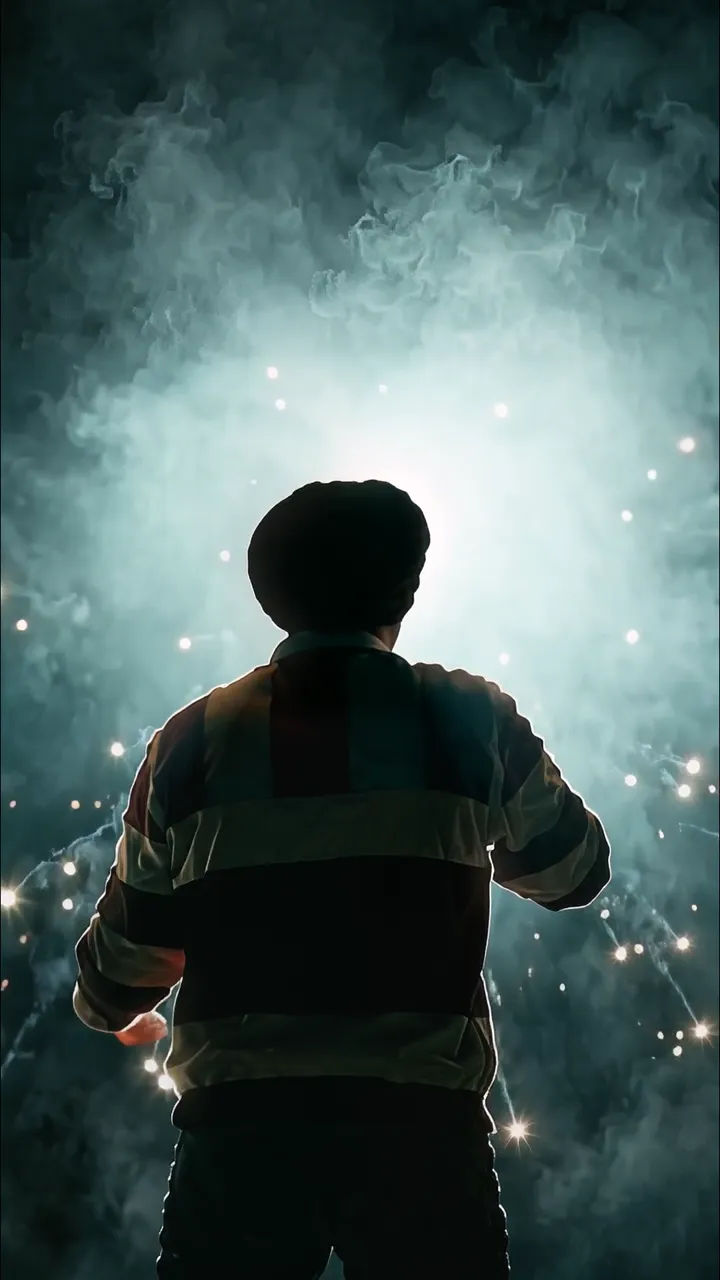 Silhouette Of Man In Striped Jacket Facing Glowing Smoke And Sparkles