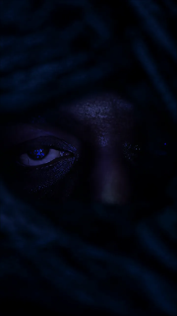 Mysterious Blue Glowing Eye With Dark Dreadlocks